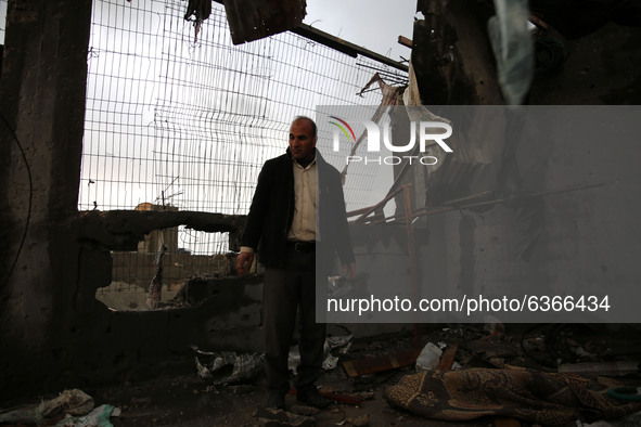 A Palestinian man inspects a damaged house near the border fence with Israel, in central Gaza Strip January 20, 2021. 