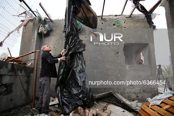 A Palestinian man inspects a damaged house near the border fence with Israel, in central Gaza Strip January 20, 2021. 
