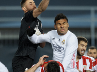 Unai Simon of Athletic makes a save front to Casemiro of Real Madrid during the Supercopa de Espana Semi Final match between Real Madrid and...