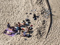 Young people relaxing on a beach under the Poniatowski bridge on the Wisla river in Warsaw. June 12, 2015, Warsaw, Poland
 (
