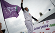 An unionist, Pauline Salingue, stands on a riot police bus. Doctors, nurses, nursing auxil...