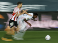 Oscar De Marcos of Athletic and Vinicius Junior of Real Madrid compete for the ball during the Supercopa de Espana Semi Final match between...