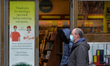 People wearing face masks seen at the entrance to 'Eason and Son' in Dublin city center du...