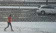 Young woman walking during the heavy snowfall is seen in Gdynia, Poland on 28 January 2021...