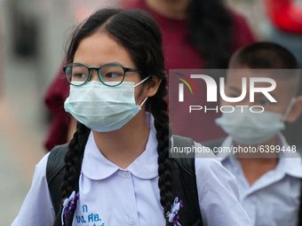 Elementary school students wearing a face mask as a preventive measure arriving at Sri Iam Anusorn School on February 1, 2021 in Bangkok, Th...