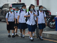 Elementary school students wearing a face mask as a preventive measure arriving at Sri Iam Anusorn School on February 1, 2021 in Bangkok, Th...