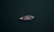 Indian boatmen sail a boat as they catch fishes for their livinghood,at river Yamuna,in Al...