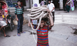 A boy doing child labor by carrying bunch of ropes on his head on June 15, 2015 in Dhaka,...