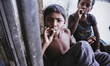 Kajol,a 13 years old boy smoking cigarette with his friend  on June 15, 2015 in Dhaka, Ban...