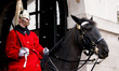 A member of the Household Cavalry sits on duty during snowfall on Whitehall in London, Eng...