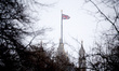 A Union Jack flag flies in snowfall from the top of the Victoria Tower of the Houses of Pa...