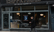 A man wearing a face mask walks in front of Caffe Nero in Dublin city center during Level...