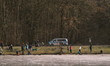 police cars patrol the pond Decksteiner Weiher in Cologne, Germany, on February 12, 2021...