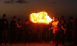 A Palestinian man show his skills with perform fire breathing on Gaza Beach during sunset,...