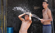 Children bathe and play with water on a hot day on June 17, 2015 in Gaza City, Palestine....