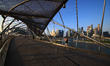 A woman jogs along the Helix Bridge with the city skyline pictured in the background at Ma...