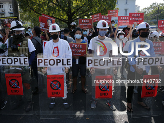 Myanmar protesters hold shields during a demonstration against the military coup outside the Central Bank in Yangon, Myanmar on February 15,...