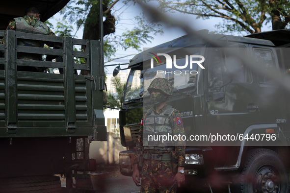 A Myanmar soldier stands guard during a demonstration against the military coup outside the Central Bank in Yangon, Myanmar on February 15,...