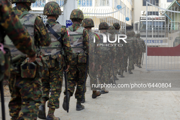 Myanmar soldiers patrol during a demonstration against the military coup outside the Central Bank in Yangon, Myanmar on February 15, 2021. 