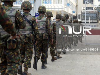 Myanmar soldiers patrol during a demonstration against the military coup outside the Central Bank in Yangon, Myanmar on February 15, 2021. (