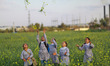 Palestinian refugee schoolgirls dressed in refugee's uniforms throw the flowers as they pl...