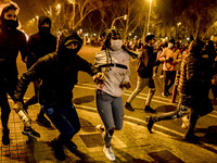 People clash with riot police during a demonstration against the imprisonment of rapper Pablo Hasel, in Barcelona, Spain, on February 19, 20...