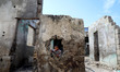 A Palestinian child looks throw a hole in wall in the Shati camp for Palestinian refugees...
