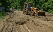 A JCB remove debris at the landslide area along the National Highway 29 after heavy monsoo...
