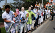 Indian Youth Congress activists, wearing masks of Prime Minister Narendra Modi, participat...