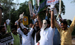 Indian Youth Congress activists, wearing masks of Prime Minister Narendra Modi, participat...