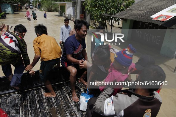 A mom and her child evacuated by pick-up car during massive floods in Pebayuran sub-district, Bekasi regency, West Java, on February 22, 202...