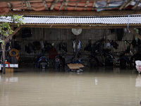 Floods hit a motorbike service shop in Pebayuran sub-district, Bekasi regency, West Java, on February 22, 2021. Massive floods hit a number...