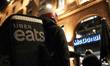 An Uber Eats worker wait in front of a McDonalds for his order. Food delivery industry has...
