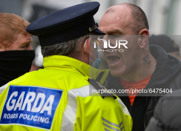 Members of Garda (Irish Police) clash with protesters during Anti-Lockdown protest outside Saint Stephen's Green entrance, during Level 5 Co...