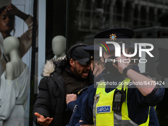 Members of Garda (Irish Police) clash with protesters or passers during Anti-Lockdown protest outside Saint Stephen's Green entrance, during...