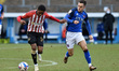 Oldham Athletic's Dylan Fage tussles with Joe Riley of Carlisle United during the Sky Bet...