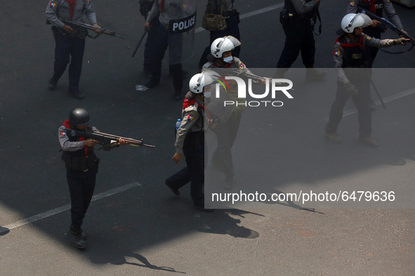 Riot police aim guns towards protesters during a violent crackdown on demonstrations against the military coup in Yangon, Myanmar on Februar...