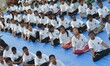 Students of National Cadet Corps (NCC) perform a mass yoga session to mark the first Inter...