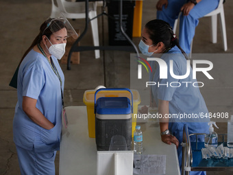 Nurses wait for hospital workers who are scheduled to receive the Sinovac COVID19 vaccine during a ceremonial vaccination program held insid...