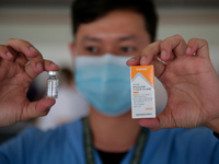 A nurse shows the Sinovac COVID19 vaccine to the media during a ceremonial vaccination program held inside a sports stadium in Marikina City...