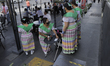 Restaurant waitresses serve diners in the streets of Mexico City's Historic Center during...