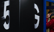A person wearing a face mask walks by a 5G Galaxy Samsung S20Ultra5G advertissment on Graf...