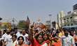 Activists shout slogans, carries a cut out of India's Prime Minister Narendra Modi, placar...