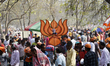 Activists shout slogans, carries a cut out of India's Prime Minister Narendra Modi, placar...