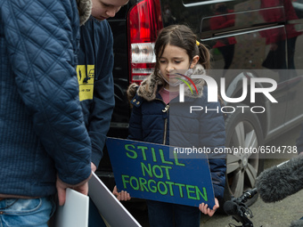 LONDON, UNITED KINGDOM - MARCH 08, 2021: Richard Ratcliffe's daughter Gabriella (6) reads support messages during a protest outside the Emba...