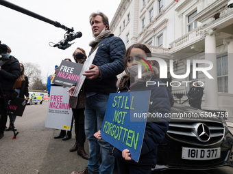 LONDON, UNITED KINGDOM - MARCH 08, 2021: Richard Ratcliffe and his daughter Gabriella (6) protest outside the Embassy of Iran in London for...