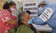 A person receives a dose of Pfizer-BioNTech Covid-19 vaccine before inject to an elderly,...