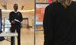 Security guard asks at a shopping mall asks shoppers novel coronavirus (COVID-19) screenin...