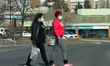 People wearing face masks to protect them from the novel coronavirus (COVID-19) while walk...