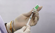 A health worker prepares a dose of Covid-19 vaccine (COVISHIELD) at a Government Hospital...